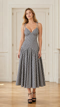 Front view of model wearing black and white gingham midi dress