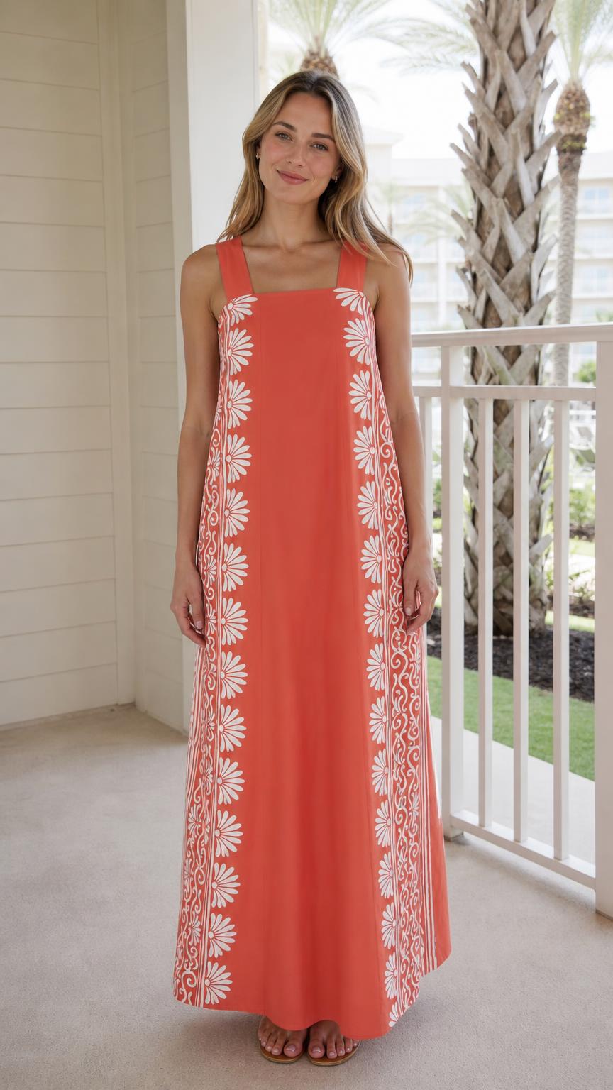 Front view of woman wearing coral maxi dress with side print panels