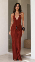 Model wearing rust halter maxi dress from the front