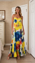 Front view of model wearing bright yellow floral maxi dress
