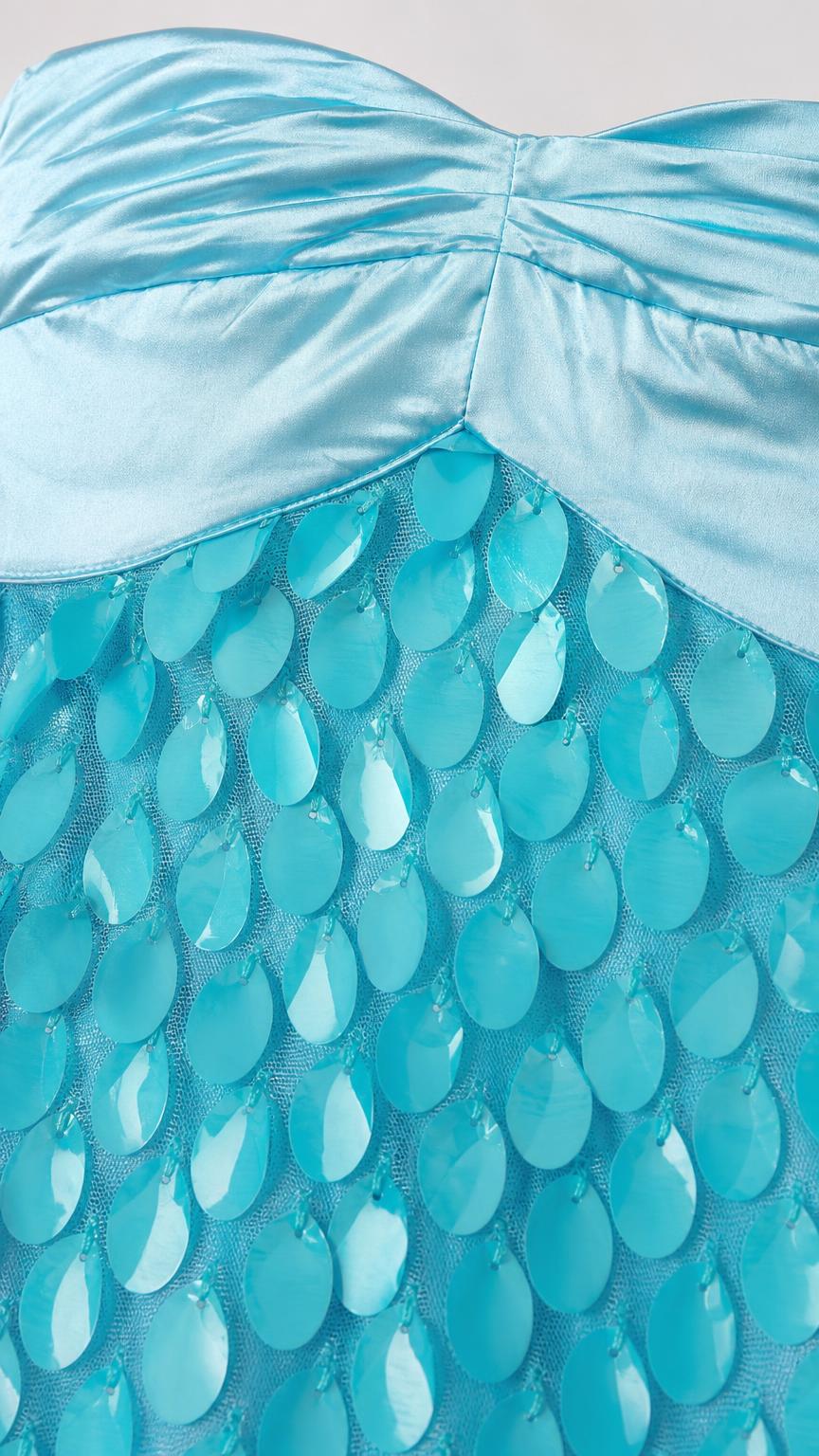 Close-up detail of satin bodice and textured turquoise appliqués