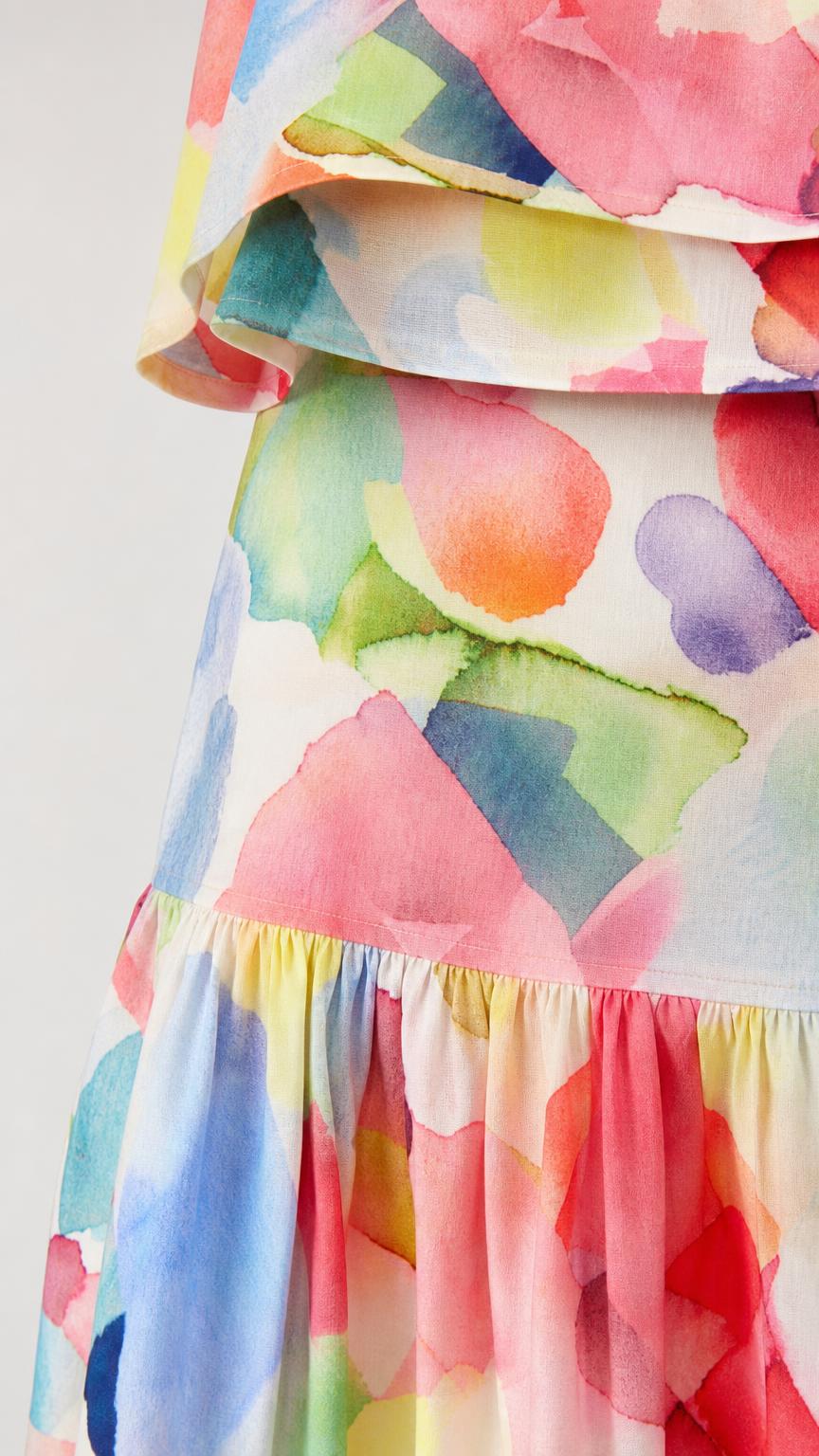 Close-up detail of watercolor print fabric and tiered skirt hem