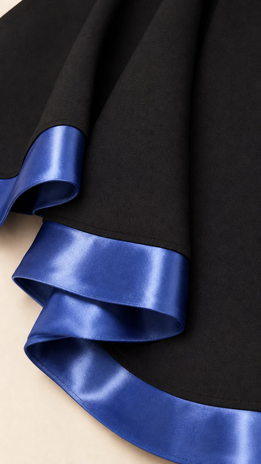 Close-up of smooth fabric and vibrant blue satin hem trim