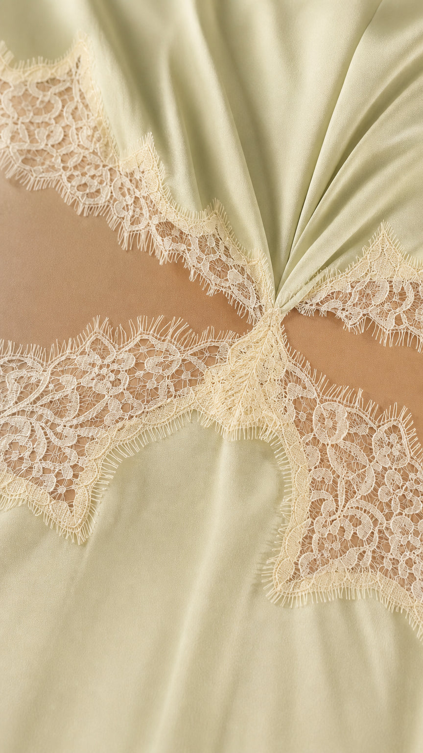 Close-up detail of lace trim and waist cutout on satin dress