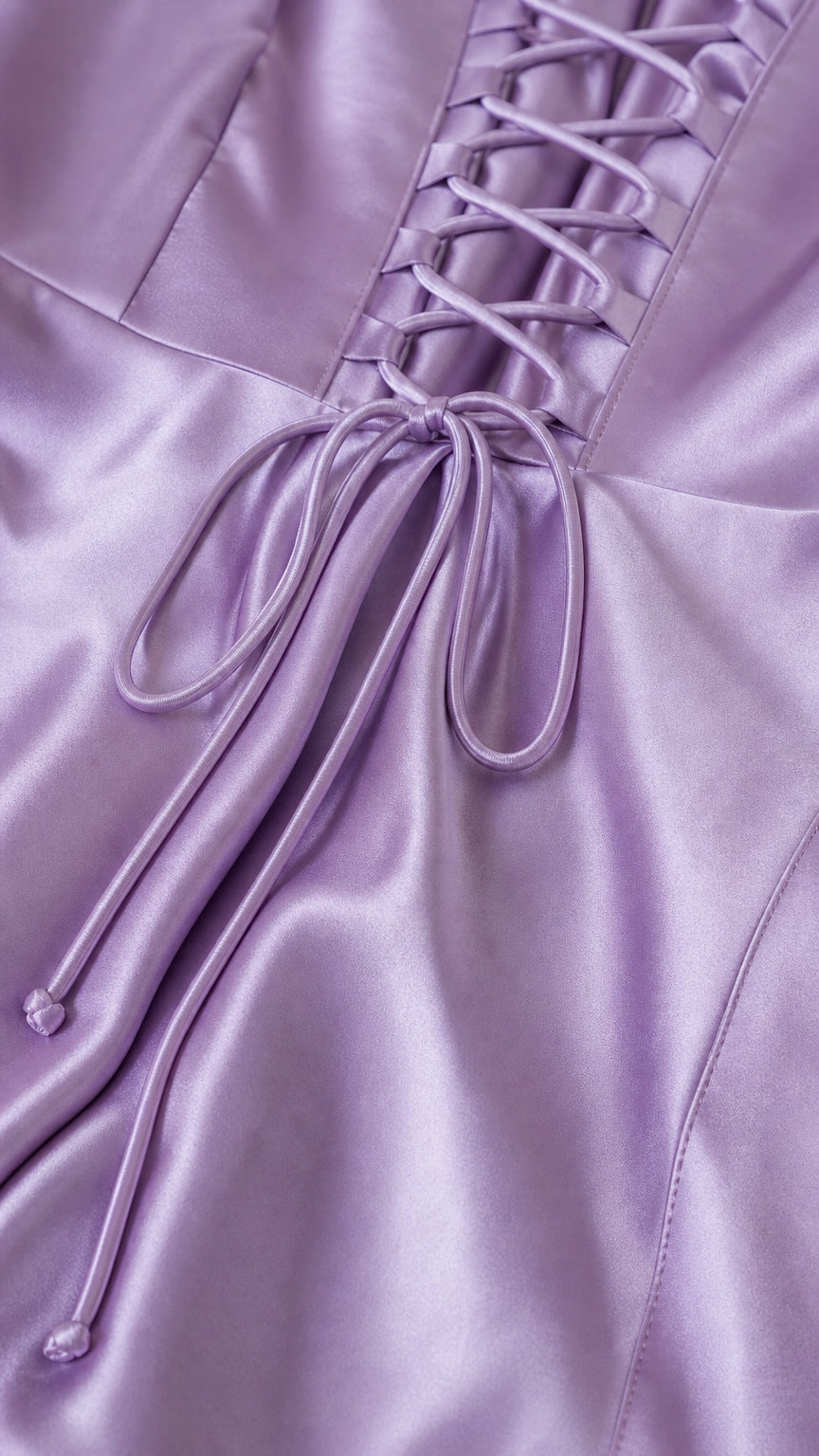 Close-up of the adjustable lace-up back on lavender satin fabric