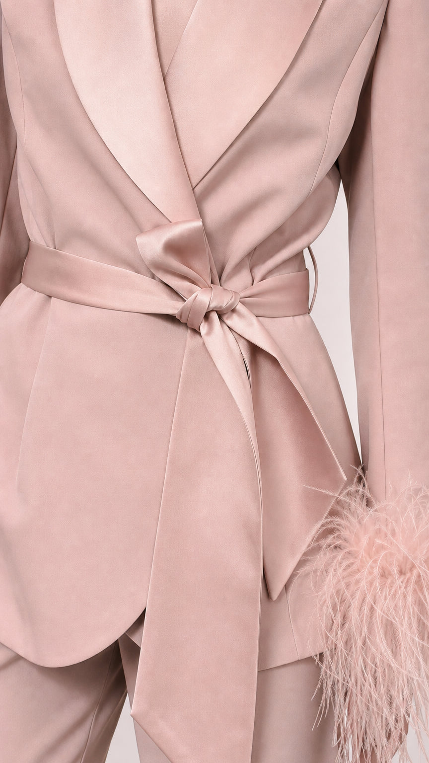 Close-up of pink satin blazer wrap tie and lapel detail