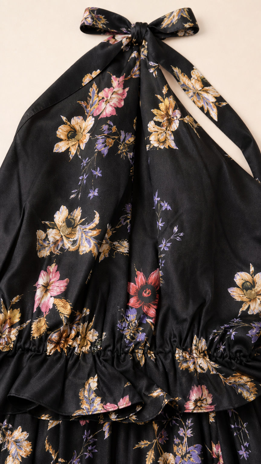 Close-up detail of black floral print fabric and back tie closure
