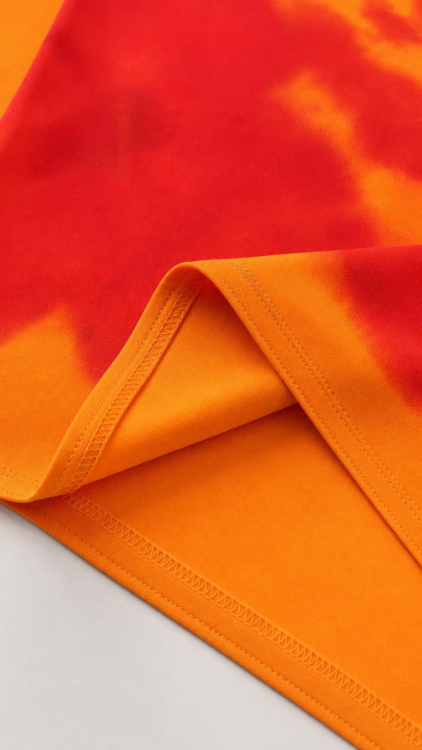 Close-up of fabric texture and hemline of orange dress
