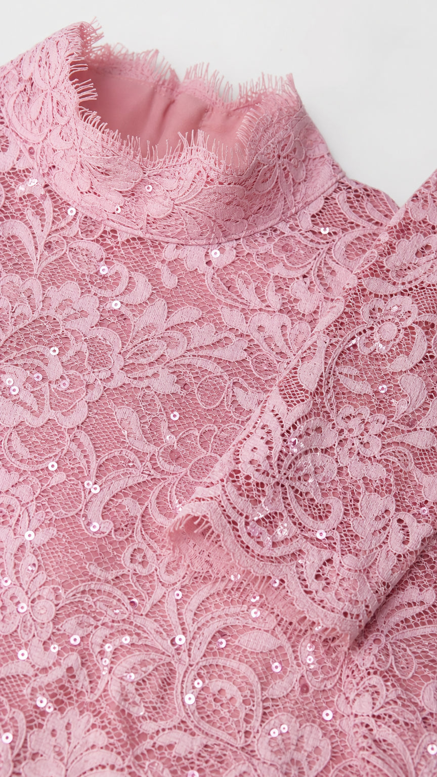 Close-up detail of pink lace texture and neckline